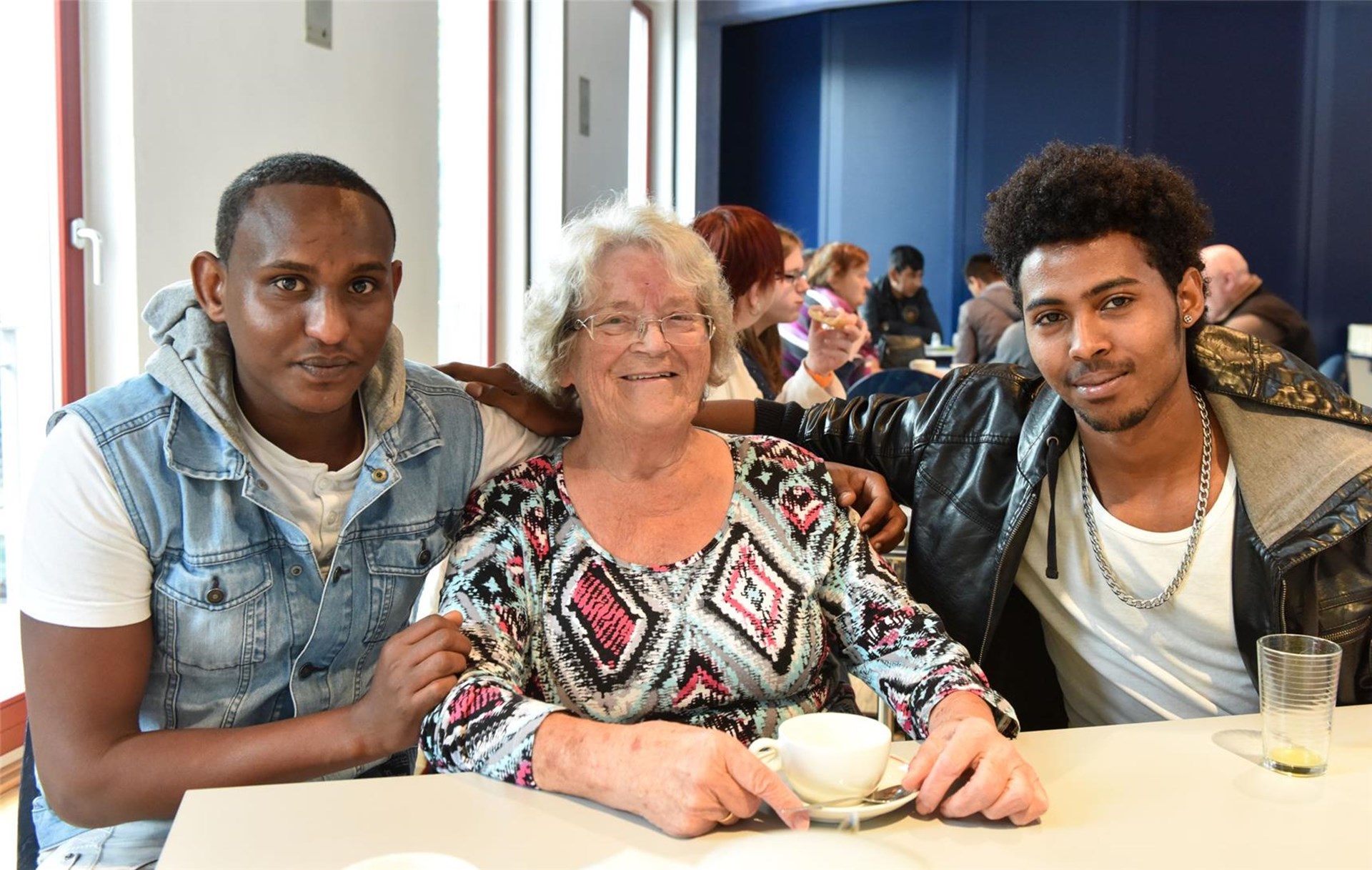 ältere  Frau zusammen mit zwei jungen Männern